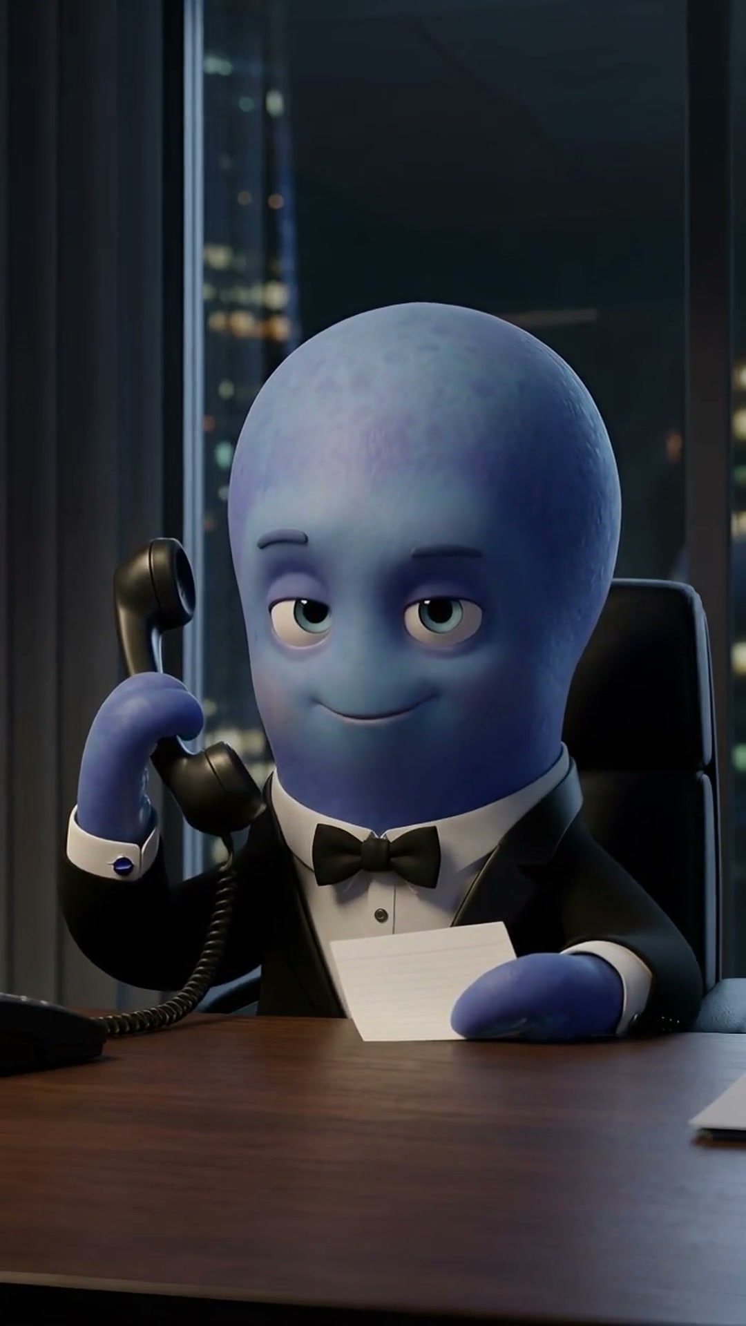 Tustin at his desk in a tuxedo cuff, a phone to his ear, glancing at a card held in one tentacle.